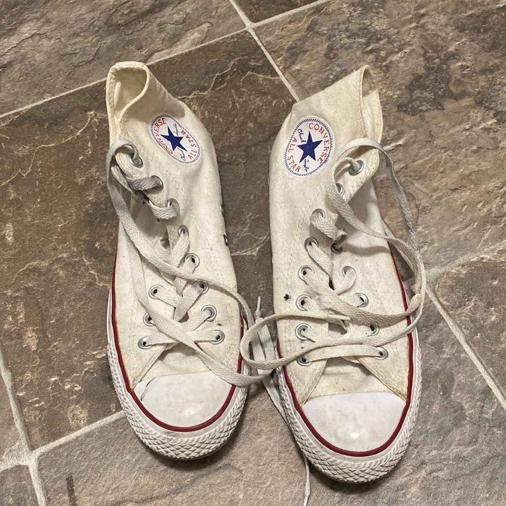 White high top converse. Worn a few times and has some black stains on the strin